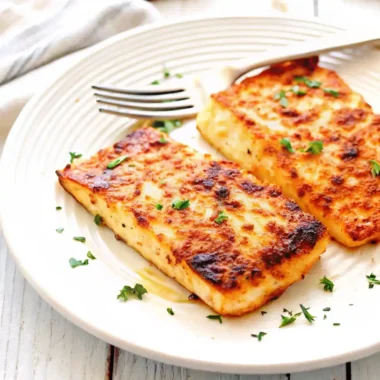 grilled halibut fillet on charcoal grill with lemon and herbs